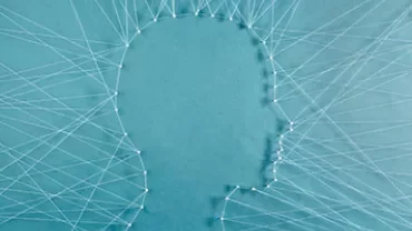Contour d'une tête formé avec des fils sur fond bleu.