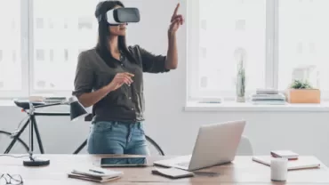 Person using virtual reality headset in modern office.