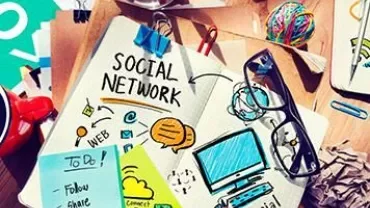 Desk with social network sketches and various stationery.