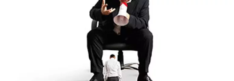 Person in a chair shouting through a megaphone at a smaller individual.