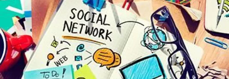 Desk with social network sketches and various stationery.