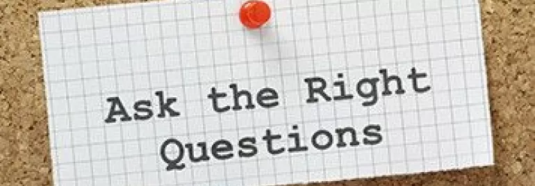 Corkboard with note reading 'Ask the Right Questions'.