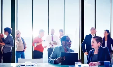 Business team having a meeting in a modern office with large windows.